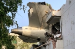 (FILES) The tail of Air India flight 171 is pictured after it crashed in a residential area near the airport in Ahmedabad on June 12, 2025. Indian investigators have successfully retrieved data from the black boxes of a London-bound Boeing plane, the government said on June 26, after the passenger jet crashed in one of the deadliest air disasters in decades, killing at least 265 people on board and on the ground. (Photo by Sam PANTHAKY / AFP)
